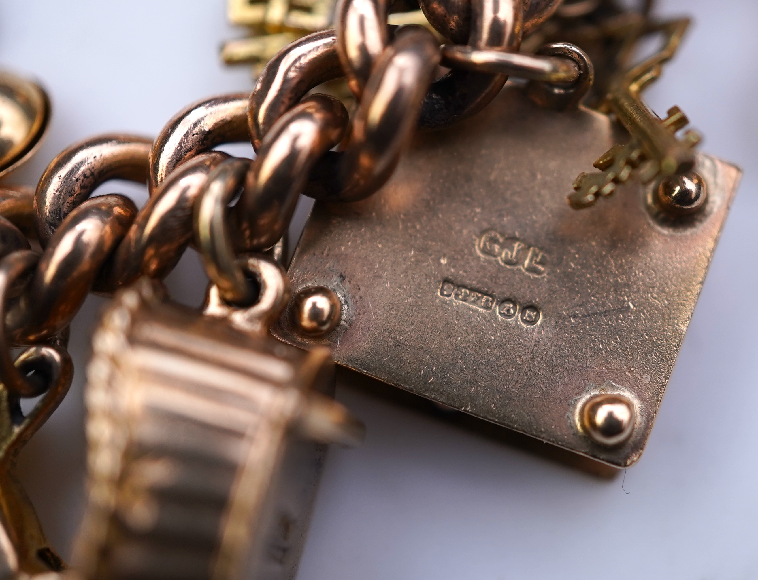 A 9ct gold charm bracelet, mid 20th century